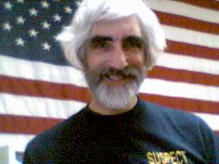 Cheshire wearing t-shirt that says 'Suspect'